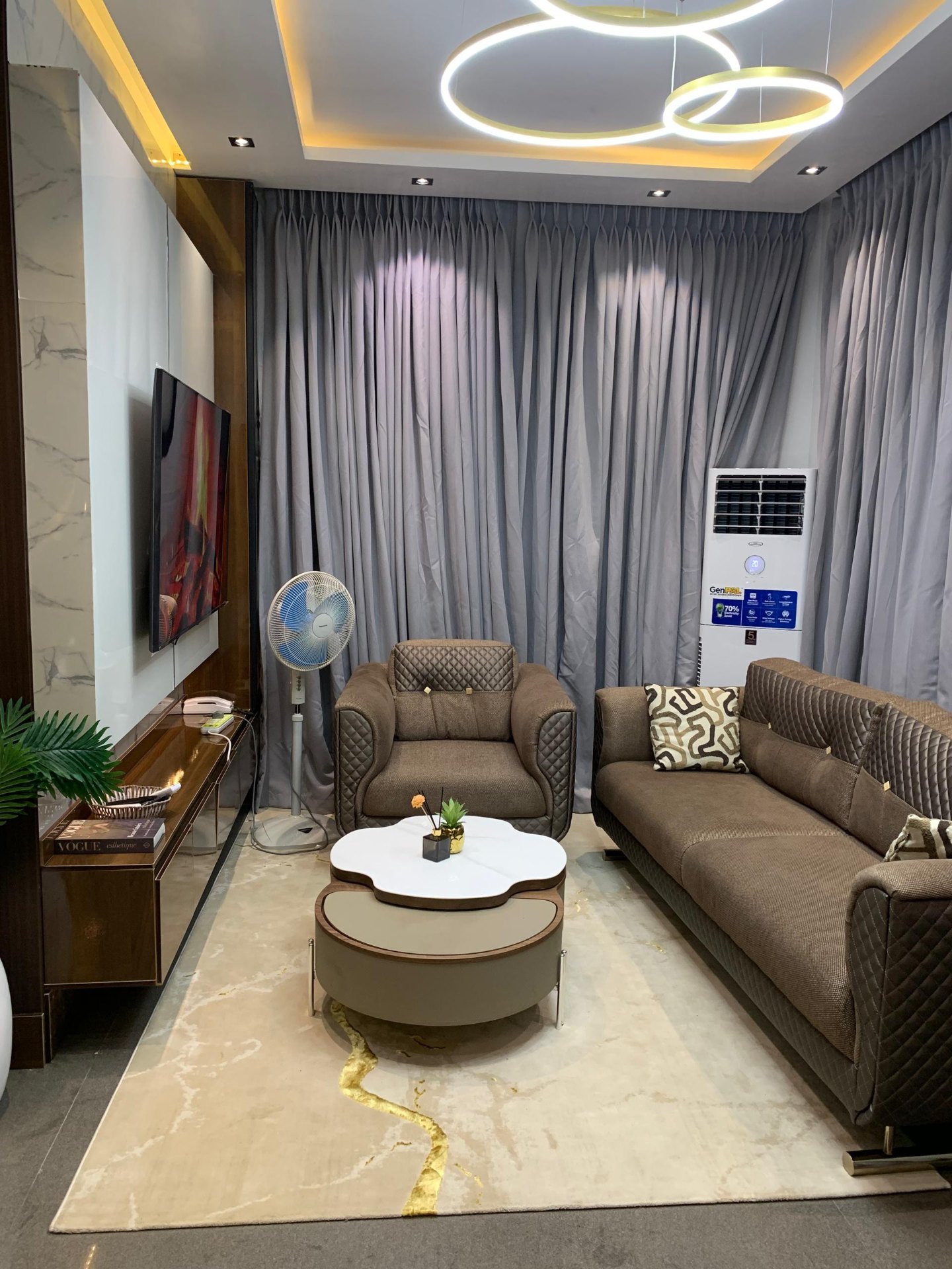 Sitting room with ring chandelier and quilted sofa