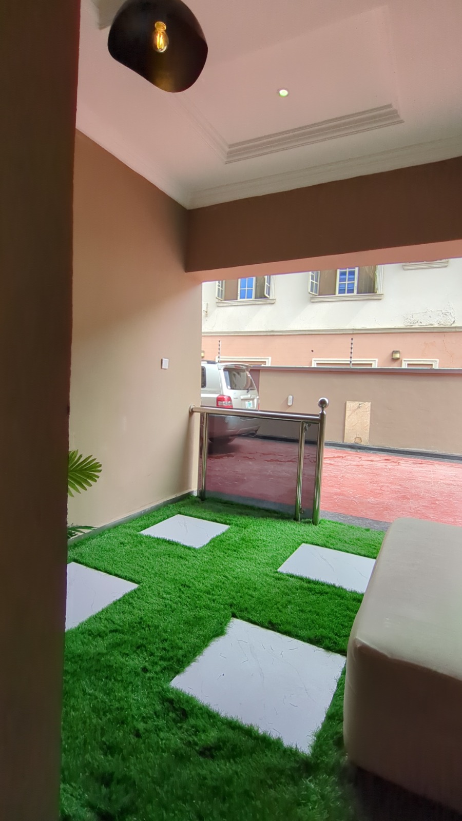 Secure gated estate entrance with lush greenery